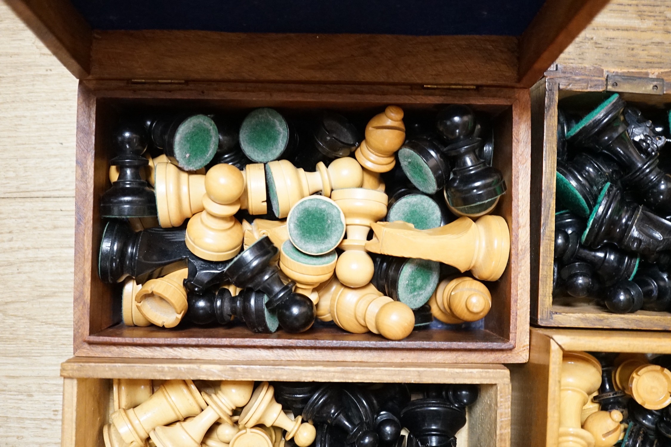 A collection of four wooden chess sets and a clock